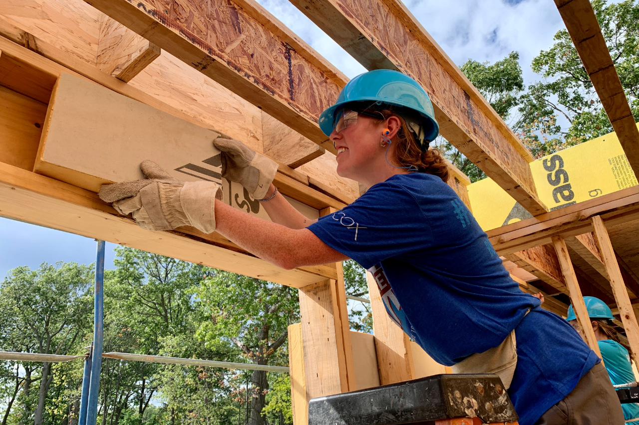 A construction volunteer putting foam block into a header