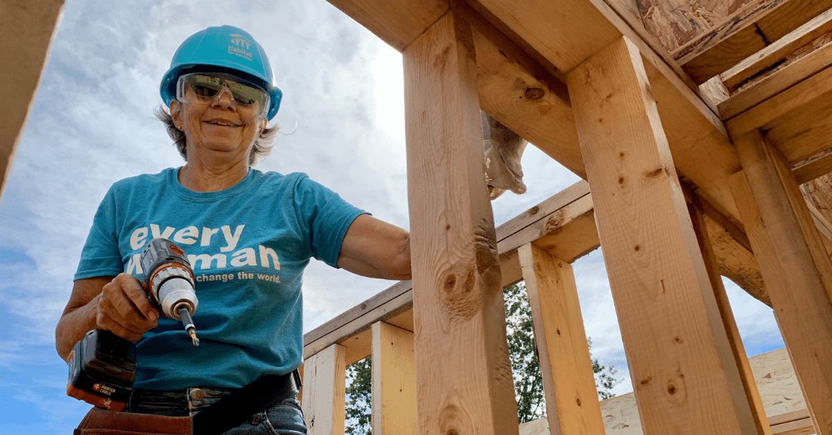 A Habitat volunteer wearing an "every woman has the power to change the world" t-shirt